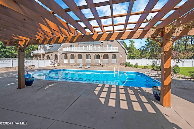 view of swimming pool with a patio area and a pergola