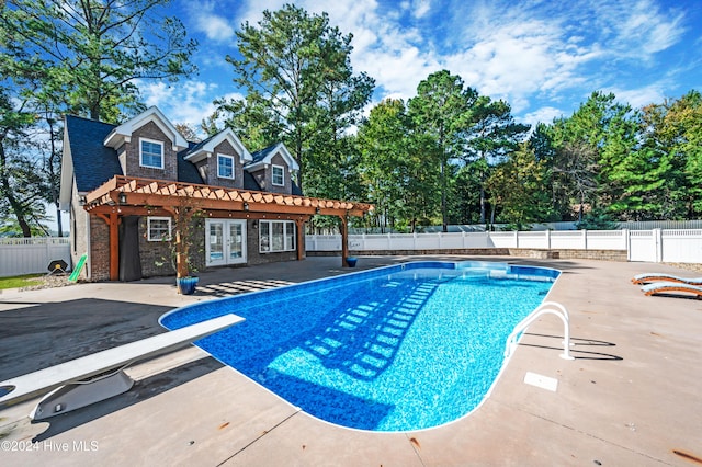 view of swimming pool with a patio, a pergola, french doors, and a diving board