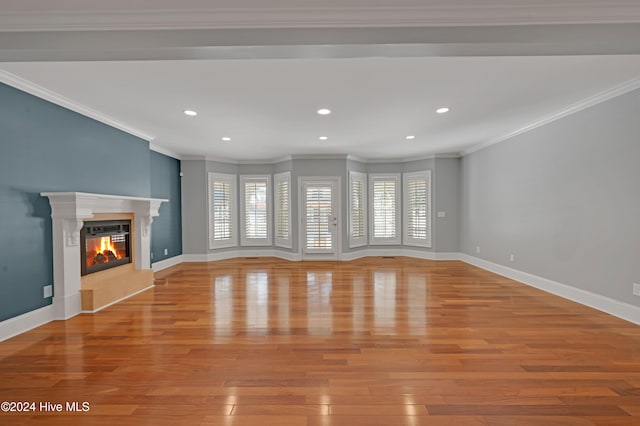 unfurnished living room with light hardwood / wood-style floors and crown molding