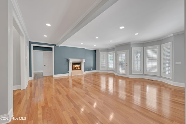 unfurnished living room featuring light hardwood / wood-style flooring and crown molding