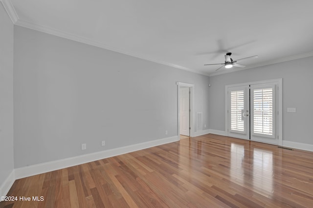 empty room featuring ceiling fan, light wood-type flooring, french doors, and ornamental molding