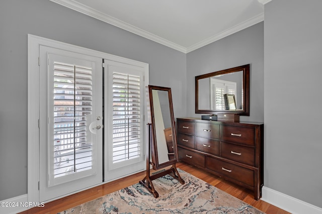 doorway featuring light wood-type flooring and ornamental molding