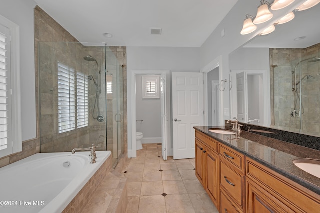 full bathroom with toilet, vanity, plus walk in shower, and tile patterned flooring