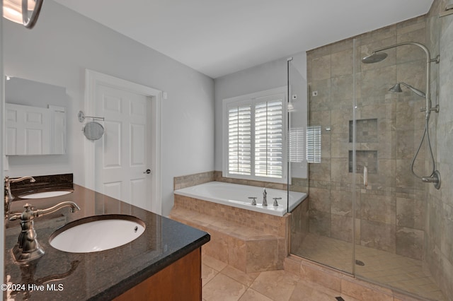 bathroom featuring vanity, tile patterned flooring, and separate shower and tub