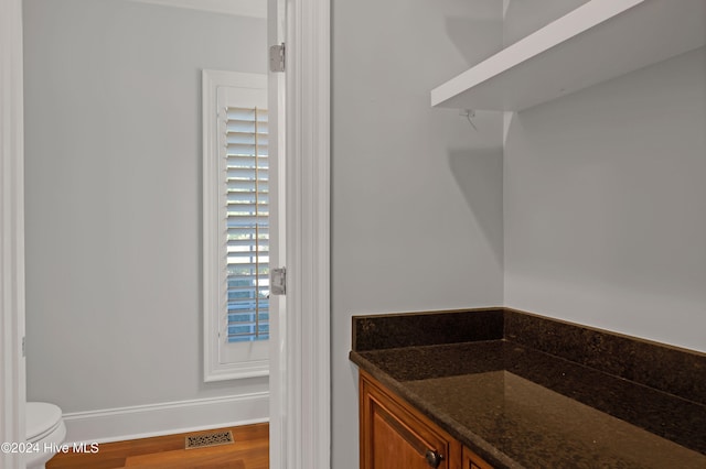 bathroom featuring hardwood / wood-style flooring and toilet