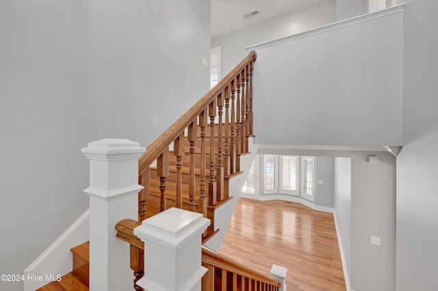 stairs with hardwood / wood-style flooring