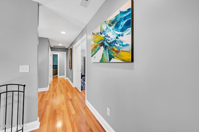 corridor with hardwood / wood-style floors