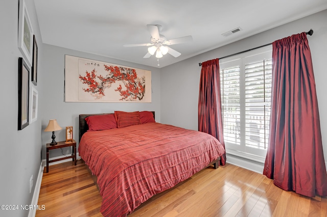 bedroom with hardwood / wood-style flooring and ceiling fan