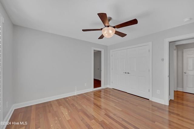 unfurnished bedroom featuring a closet, light wood-type flooring, and ceiling fan