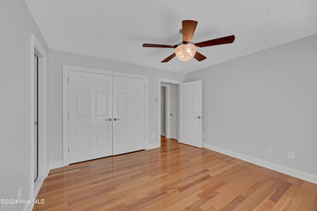 unfurnished bedroom featuring a closet, light wood-type flooring, and ceiling fan