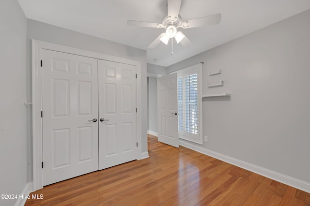 unfurnished bedroom featuring a closet, light wood-type flooring, and ceiling fan