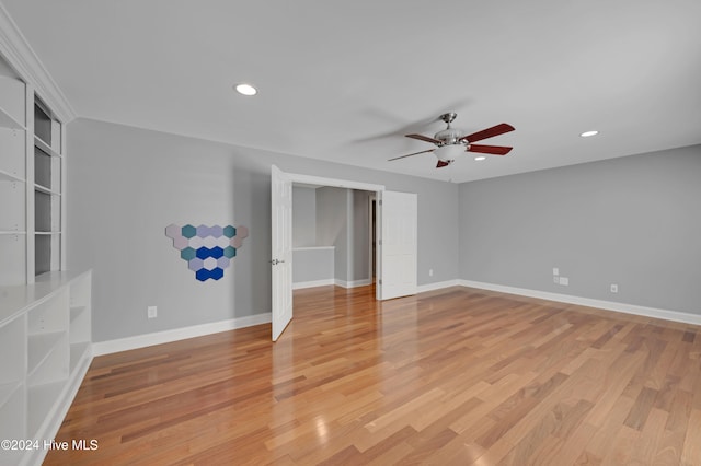 unfurnished bedroom with ceiling fan and light hardwood / wood-style floors