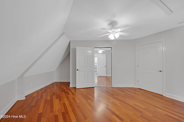 bonus room with hardwood / wood-style floors, vaulted ceiling, and ceiling fan