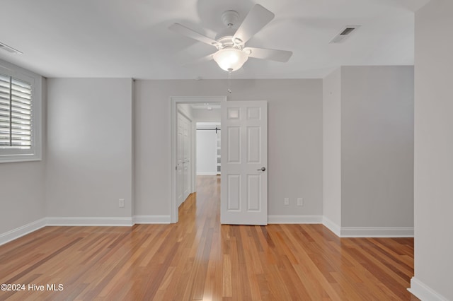 empty room with light hardwood / wood-style floors and ceiling fan