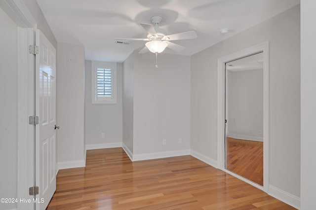 unfurnished bedroom with ceiling fan and light hardwood / wood-style flooring