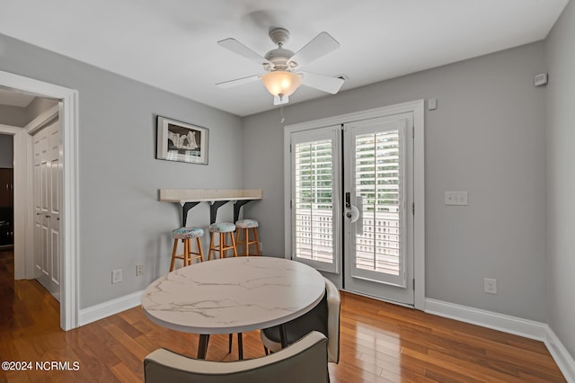 dining space featuring hardwood / wood-style floors, ceiling fan, and french doors