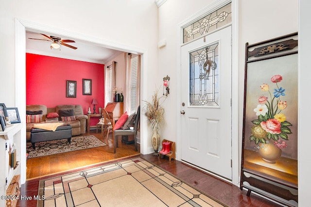 entrance foyer with hardwood / wood-style floors, ceiling fan, and crown molding