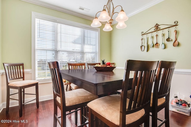 dining space featuring an inviting chandelier, dark wood-type flooring, and ornamental molding