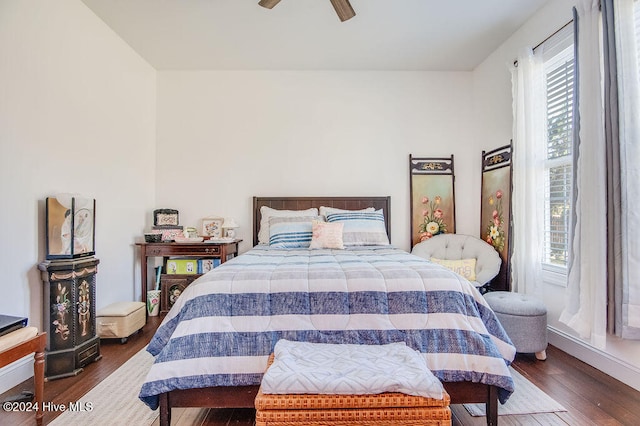 bedroom with dark hardwood / wood-style floors, multiple windows, and ceiling fan