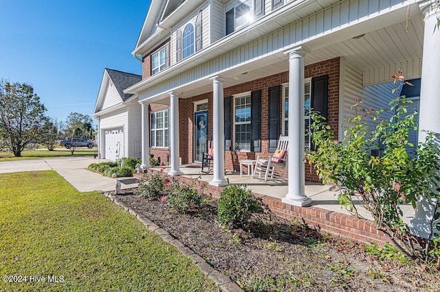 doorway to property featuring covered porch and a garage