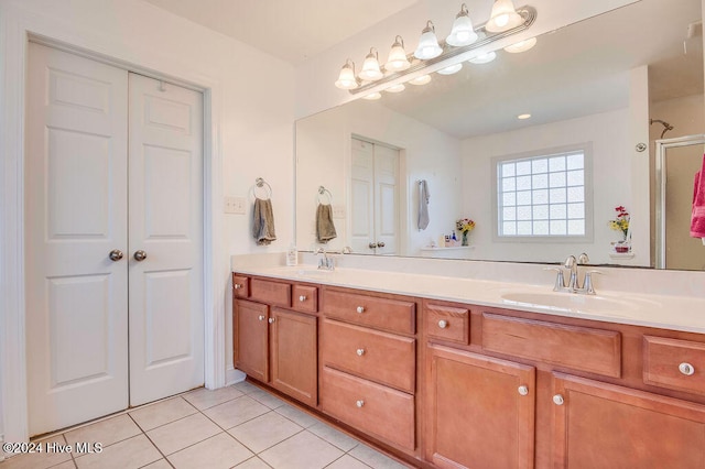 bathroom with tile patterned floors, vanity, and a shower with shower door