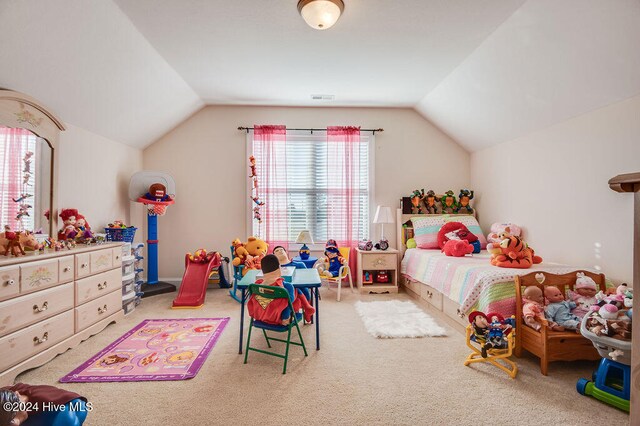 bedroom featuring carpet and lofted ceiling