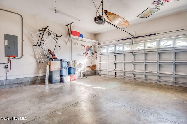 garage with electric panel and a garage door opener