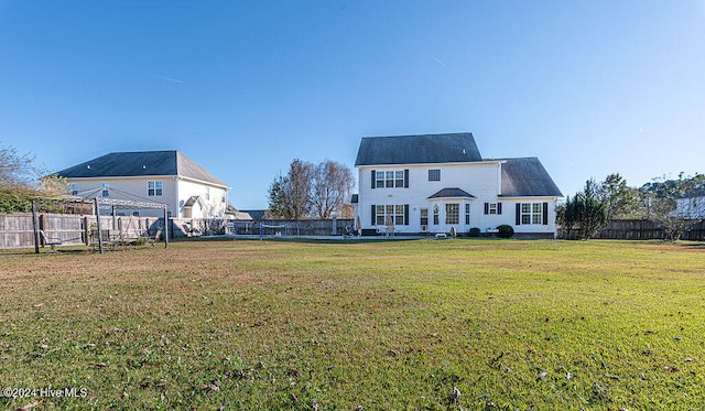 rear view of property featuring a yard