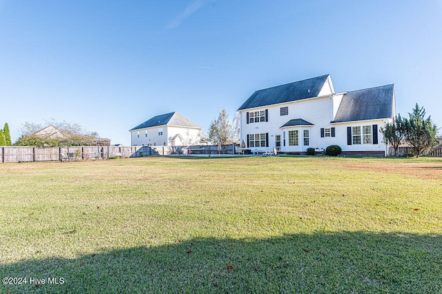 rear view of property with a lawn