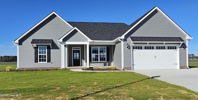 view of front of home featuring metal roof, driveway, a front lawn, and an attached garage