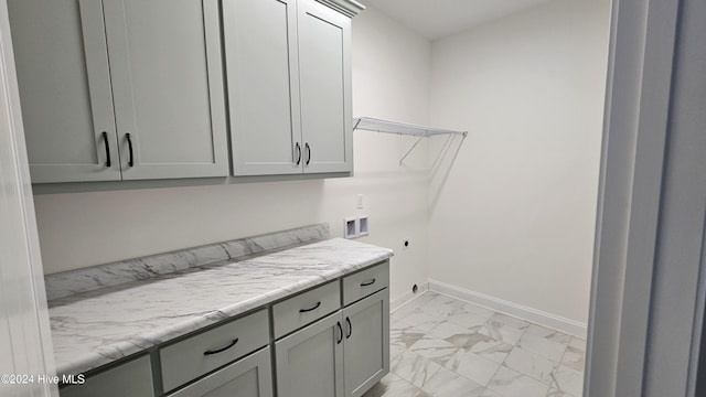 clothes washing area with washer hookup, marble finish floor, cabinet space, hookup for an electric dryer, and baseboards