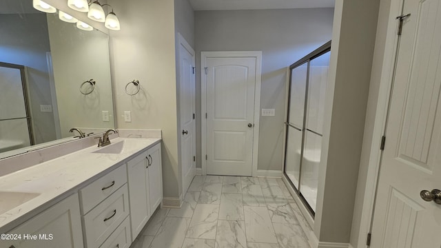 full bathroom with marble finish floor, double vanity, a stall shower, a sink, and baseboards