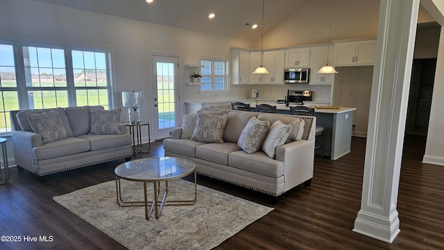 living room featuring high vaulted ceiling, recessed lighting, dark wood-style flooring, and baseboards