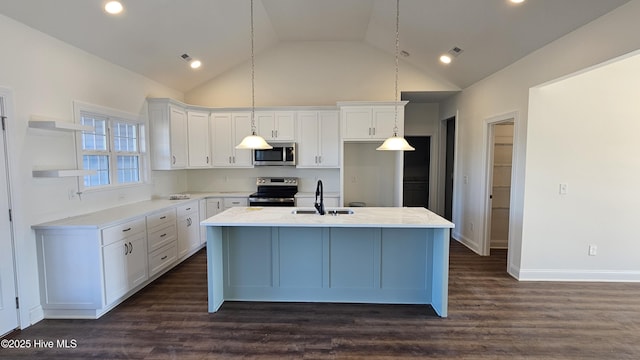 kitchen featuring white cabinets, stainless steel appliances, a sink, and light countertops