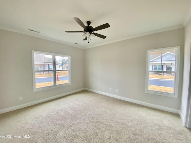 carpeted empty room with ornamental molding and ceiling fan