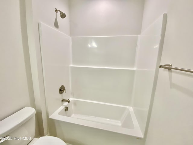 bathroom with toilet and washtub / shower combination