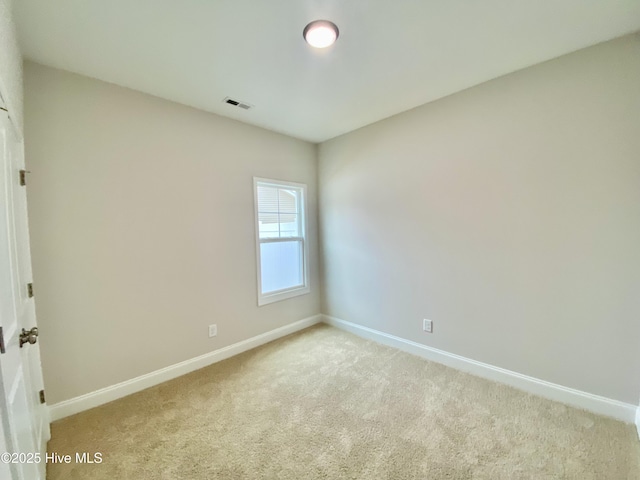 spare room with light colored carpet