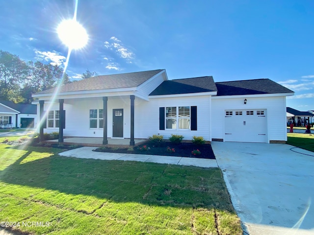 ranch-style home with a garage, a front lawn, and a porch