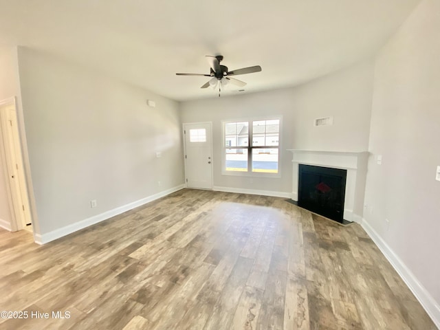 unfurnished living room featuring ceiling fan and light hardwood / wood-style flooring