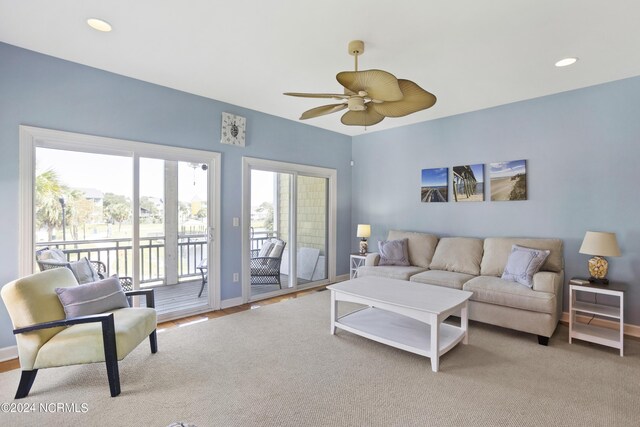 balcony featuring an outdoor living space, a water view, and ceiling fan