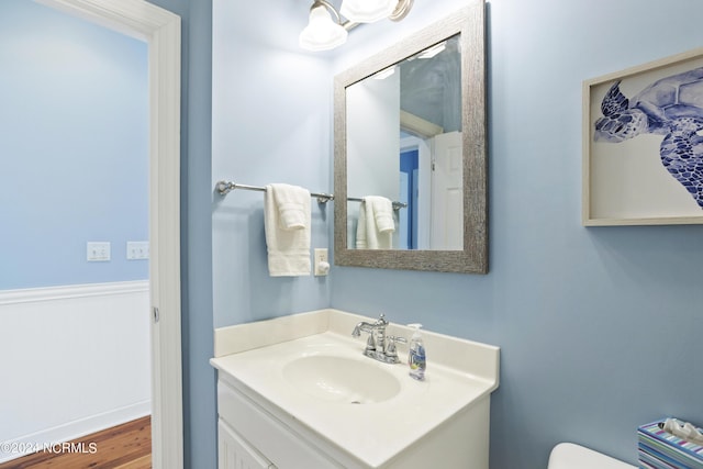 bathroom featuring toilet and vanity