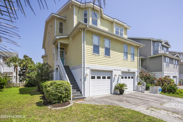 view of front facade featuring a front lawn, driveway, an attached garage, and stairs