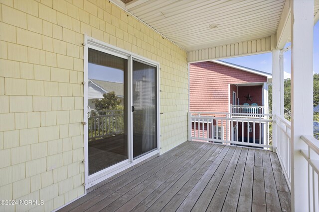 wooden deck featuring a water view