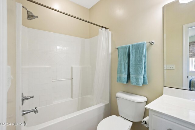 full bathroom featuring vanity, toilet, and shower / bath combination with curtain