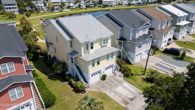 birds eye view of property with a residential view and a water view