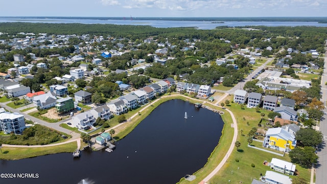 birds eye view of property with a water view and a residential view