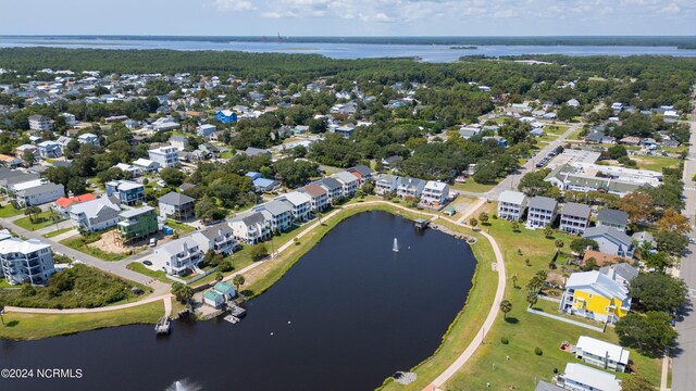 drone / aerial view with a water view and a residential view