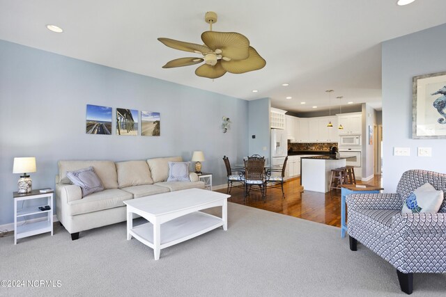 living area with recessed lighting, ceiling fan, baseboards, and a tile fireplace