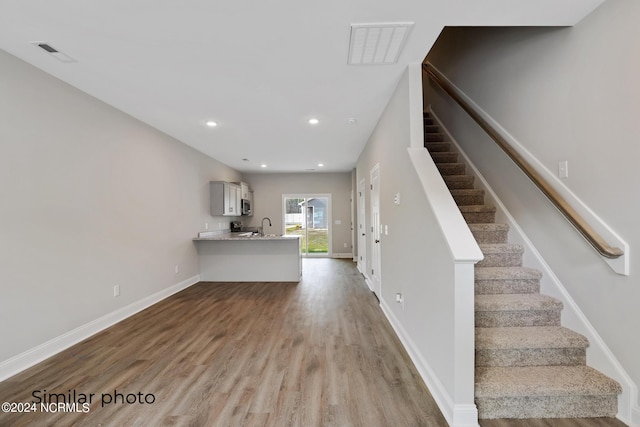 interior space featuring hardwood / wood-style flooring and sink