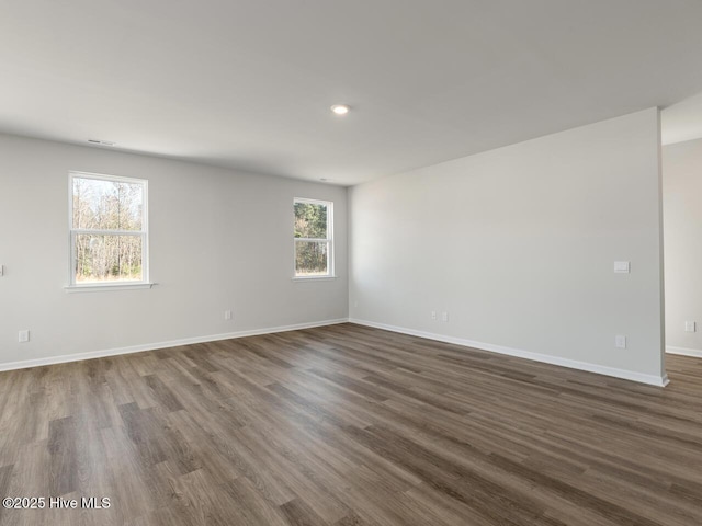 spare room with dark hardwood / wood-style flooring